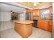 Open kitchen with granite countertops, stainless steel appliances, and view of the living area at 2 Pirates Cv, Ormond Beach, FL 32176