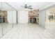 Spacious living room with tile flooring, a stone fireplace, and sliding glass doors at 2 Pirates Cv, Ormond Beach, FL 32176
