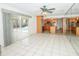 Bright living room with tile floors, kitchen view, and glass doors to the pool area at 2 Pirates Cv, Ormond Beach, FL 32176