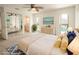 Bright main bedroom with ceiling fan, ensuite access, and view of the pool through windows at 2 Pirates Cv, Ormond Beach, FL 32176