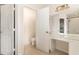 Bathroom featuring double doors, a vanity area, and a toilet inside an ensuite at 2110 Stockton Dr, Sanford, FL 32771