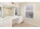 Bright bathroom with double sinks, vanity area, large mirror, and a window providing natural light at 2110 Stockton Dr, Sanford, FL 32771