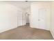 Spacious carpeted bedroom with double doors and an ensuite bathroom at 2110 Stockton Dr, Sanford, FL 32771