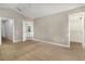 Carpeted bedroom featuring walk in closet and ensuite bathroom with a neutral color palette at 2110 Stockton Dr, Sanford, FL 32771