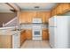 Functional kitchen with appliances and white tile flooring, open to staircase at 2110 Stockton Dr, Sanford, FL 32771