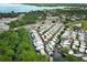 Aerial view of community homes on canals near a lake, surrounded by mature trees and lush landscaping at 229 Rue De Fontaine, Tavares, FL 32778