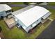 An aerial view of the home shows the roof, yard, driveway, and surrounding properties at 229 Rue De Fontaine, Tavares, FL 32778