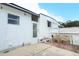 Exterior shot featuring a back entrance, small patio, and fenced yard at 229 Rue De Fontaine, Tavares, FL 32778