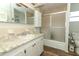 Bathroom with vanity, sink, and shower featuring sliding doors at 229 Rue De Fontaine, Tavares, FL 32778