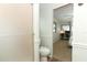 Bathroom featuring a shower, toilet, and view into the bedroom at 229 Rue De Fontaine, Tavares, FL 32778