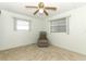 A bedroom featuring neutral carpet and a ceiling fan with windows that let in natural light at 229 Rue De Fontaine, Tavares, FL 32778