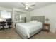 Bright bedroom with a comfortable bed, ceiling fan, and bedside table at 229 Rue De Fontaine, Tavares, FL 32778