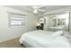 Bright bedroom with ceiling fan, mirrored closet, and study area at 229 Rue De Fontaine, Tavares, FL 32778