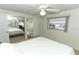Bedroom with a bed, ceiling fan, window, and adjacent bathroom at 229 Rue De Fontaine, Tavares, FL 32778