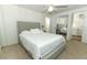 Comfortable bedroom with ceiling fan and attached bathroom access at 229 Rue De Fontaine, Tavares, FL 32778