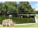 Covered boat dock on the water offers shade and protection for multiple boats at 229 Rue De Fontaine, Tavares, FL 32778