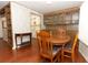 Inviting dining area with wood floors and built-in china cabinet adjacent to the open-concept kitchen at 229 Rue De Fontaine, Tavares, FL 32778
