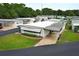 Well-maintained home featuring a covered carport and manicured landscaping in a friendly community at 229 Rue De Fontaine, Tavares, FL 32778