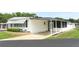 This property features a carport and well-maintained landscaping, offering comfortable, convenient living at 229 Rue De Fontaine, Tavares, FL 32778