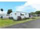 Charming single-story home with well-maintained lawn and awning-covered windows at 229 Rue De Fontaine, Tavares, FL 32778