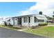 Charming home with awnings, decorative shutters and mature landscaping creating great curb appeal at 229 Rue De Fontaine, Tavares, FL 32778