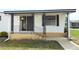 Cozy front porch featuring decorative iron railings leading to the entrance, adding charm to the home at 229 Rue De Fontaine, Tavares, FL 32778