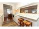A traditional eat-in kitchen features white appliances and seating at the counter at 229 Rue De Fontaine, Tavares, FL 32778