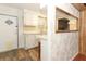 A traditional-style kitchen features white cabinets, laminate countertops, and updated flooring at 229 Rue De Fontaine, Tavares, FL 32778