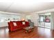 Inviting living room with wood floors, bright windows, and sliding door access to outdoor space at 229 Rue De Fontaine, Tavares, FL 32778