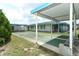 Community shuffleboard court surrounded by landscaping, with covered seating and shade trees for relaxation at 229 Rue De Fontaine, Tavares, FL 32778
