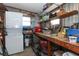 Organized storage room featuring shelving, workbench, washer, and dryer combo, providing efficient space at 229 Rue De Fontaine, Tavares, FL 32778