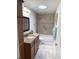Bathroom featuring a skylight, tiled shower and bathtub, vanity, and modern fixtures at 2299 Hawks Cove Cir, New Smyrna Beach, FL 32168