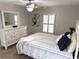 Comfortable bedroom with carpet floors, dresser, ceiling fan, and large window at 2299 Hawks Cove Cir, New Smyrna Beach, FL 32168
