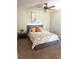 Cozy bedroom with ceiling fan, carpet floors, and decorative pillows on the bed at 2299 Hawks Cove Cir, New Smyrna Beach, FL 32168