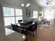 Dining room with shuttered windows, a modern chandelier, and access to the living room at 2299 Hawks Cove Cir, New Smyrna Beach, FL 32168