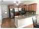 Kitchen with wood cabinets, granite countertops, and stainless steel appliances at 2299 Hawks Cove Cir, New Smyrna Beach, FL 32168