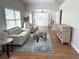 Bright living room with plantation shutters, comfortable seating, and stylish decor at 2299 Hawks Cove Cir, New Smyrna Beach, FL 32168