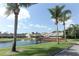Scenic view of a pond with a gazebo and a fountain surrounded by trees and homes at 2299 Hawks Cove Cir, New Smyrna Beach, FL 32168