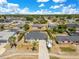 Aerial view of a charming home with a well-maintained lawn and beautiful landscaping in a quiet neighborhood at 2397 Albury Ave, Deltona, FL 32738