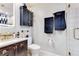 Well-lit bathroom with modern fixtures, updated vanity, drawers and granite countertop, and walk-in shower at 2397 Albury Ave, Deltona, FL 32738