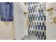 Modern bathroom featuring decorative tile shower with gold fixtures at 2397 Albury Ave, Deltona, FL 32738