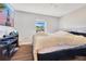 Bedroom with hardwood floors, TV, and a window with natural light at 2397 Albury Ave, Deltona, FL 32738