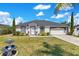 Charming single-story home with well-maintained landscaping and a two-car garage on a sunny day at 2397 Albury Ave, Deltona, FL 32738