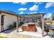 Relaxing hot tub under a covered pergola next to a BBQ grill and a view of the screened-in swimming pool at 2397 Albury Ave, Deltona, FL 32738