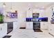 Bright kitchen features white cabinets, stainless steel appliances, updated lighting and marbled tile flooring at 2397 Albury Ave, Deltona, FL 32738