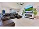 Spacious living room featuring a large leather sectional, modern fireplace, and a large television at 2397 Albury Ave, Deltona, FL 32738