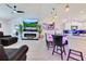 Bright and open living room with a cozy leather sectional, kitchen bar and a modern fireplace at 2397 Albury Ave, Deltona, FL 32738