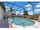 Inviting screened-in pool with clear blue water, in ground spa and a tranquil backyard setting with palm trees at 2397 Albury Ave, Deltona, FL 32738