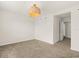 Bedroom featuring neutral carpet, white walls, hanging light and a doorway at 2949 Clever Ln, Winter Park, FL 32792