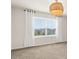 Bright bedroom with large window, neutral walls, and a modern light fixture at 2949 Clever Ln, Winter Park, FL 32792